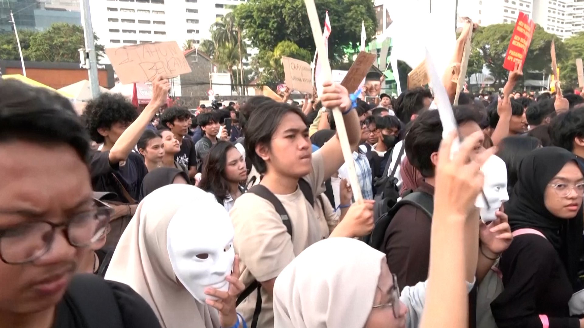 Protesters in Indonesia holding signs