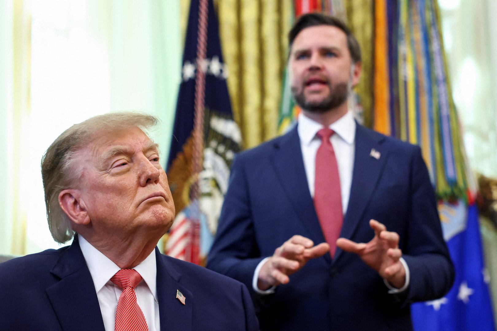 US President Donald Trump listens to Vice President JD Vance speak as they make a joint appearance in the Oval Office to announce a whistleblower program to encourage the public to report alleged fraud, at the White House in Washington, DC, US, on Oct. 20, 2026. [Kevin Lamarque/Reuters]