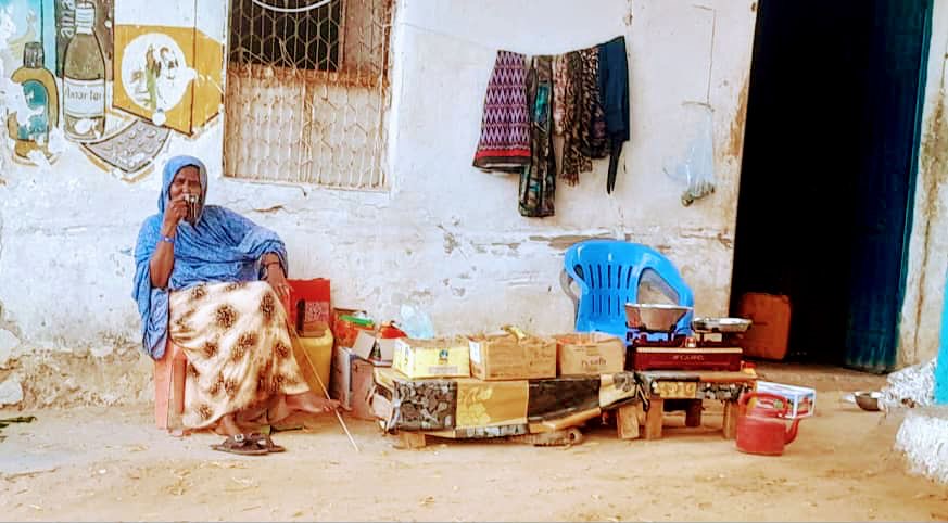 A woman sells tea at the local fish market in Bander Beyla, on Somalia’s Puntland coast [Al Jazeera]