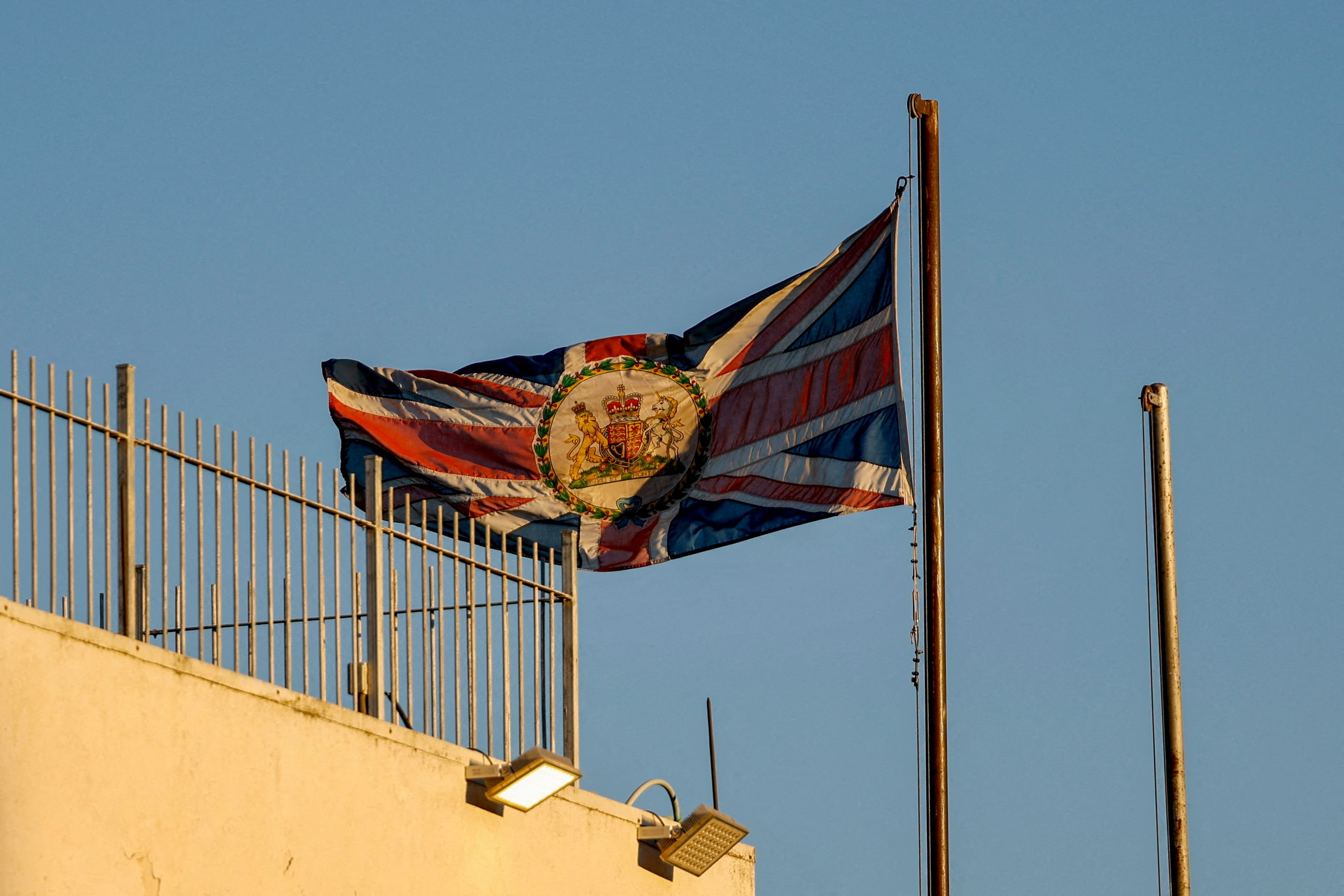 A flag waves on a building.