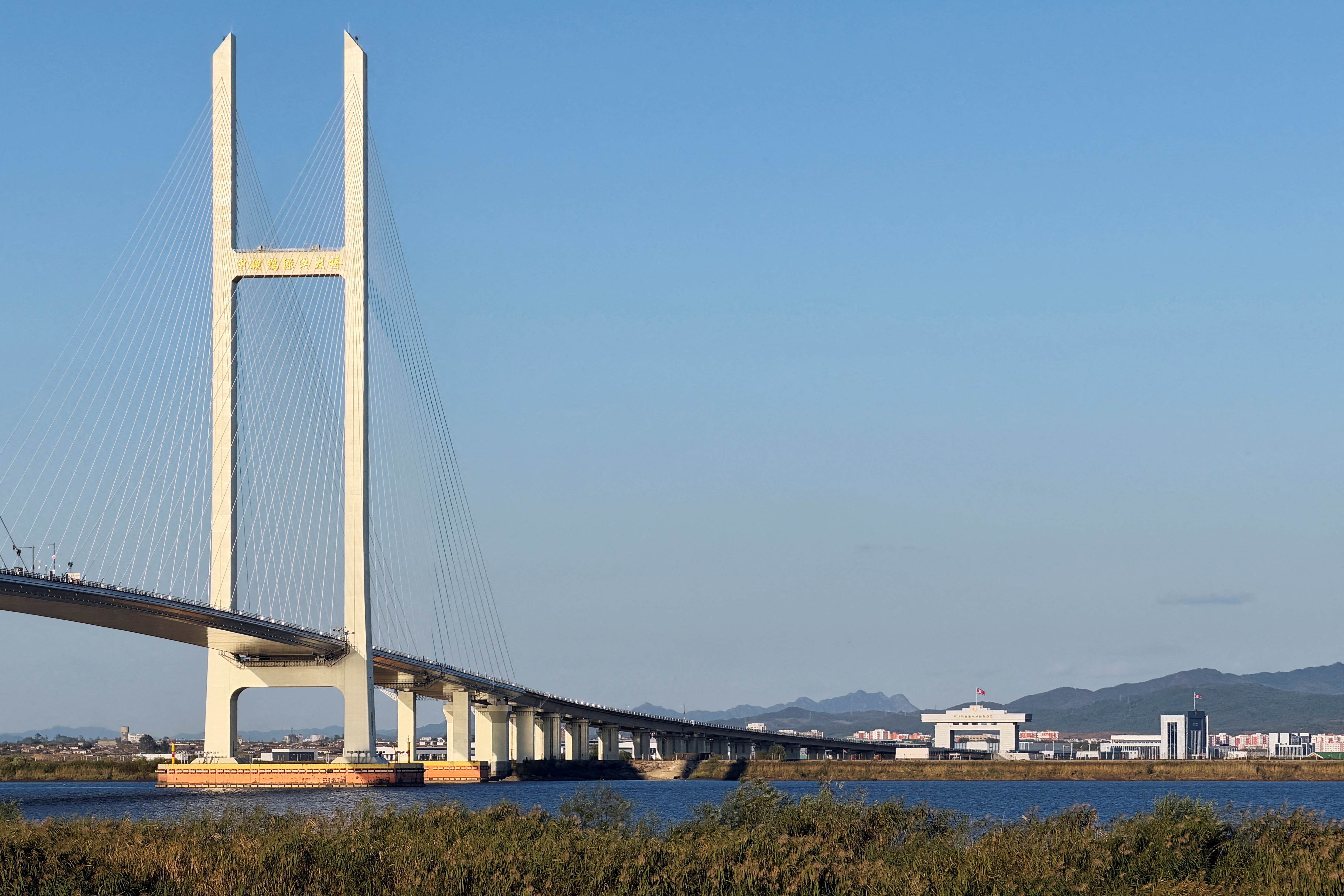 FILE PHOTO: The New Yalu River Bridge designed to connect China's Dandong New Zone and North Korea's Sinuiju, as seen from Dandong, Liaoning province, China October 5, 2026. Picture taken with a mobile phone. REUTERS/Mandy Leong/File Photo
