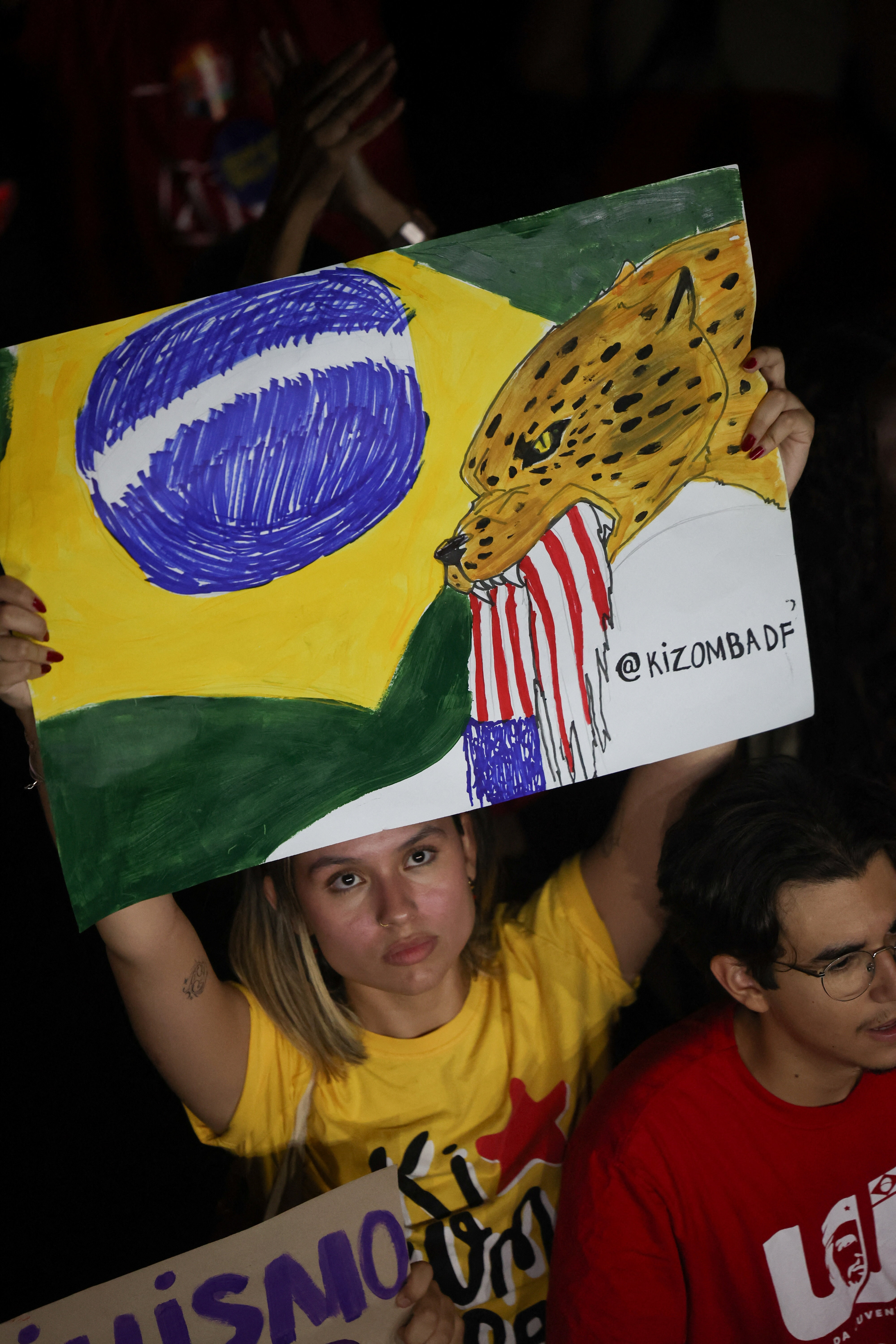 A woman holds up a sign at a protest in support of Brazilian President Luiz Inacio Lula da Silva's re-election bid