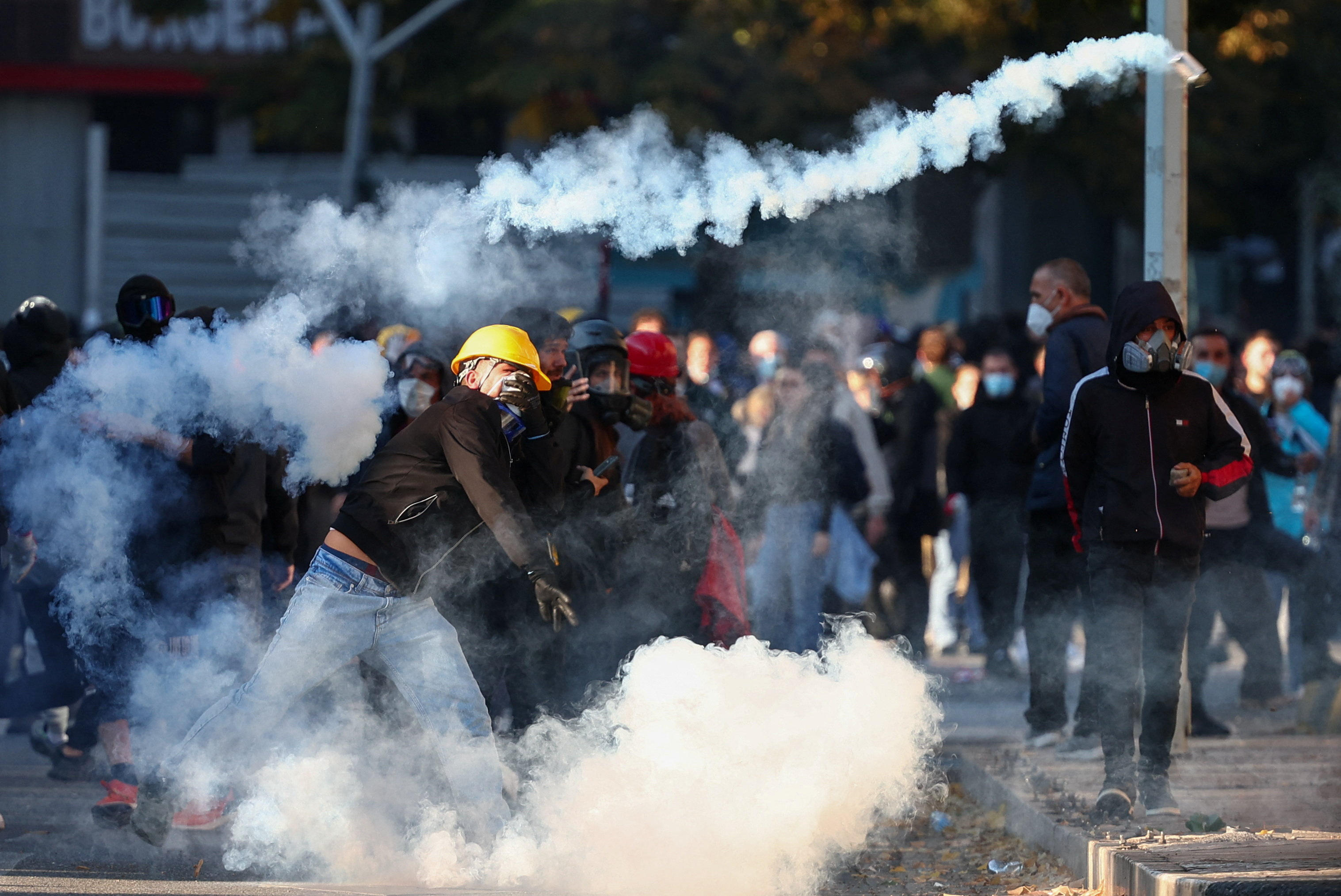 A protester throws a tear gas canister during an anti-government protest by students in Tirana, Albania, October 18, 2026. REUTERS/Florion Goga