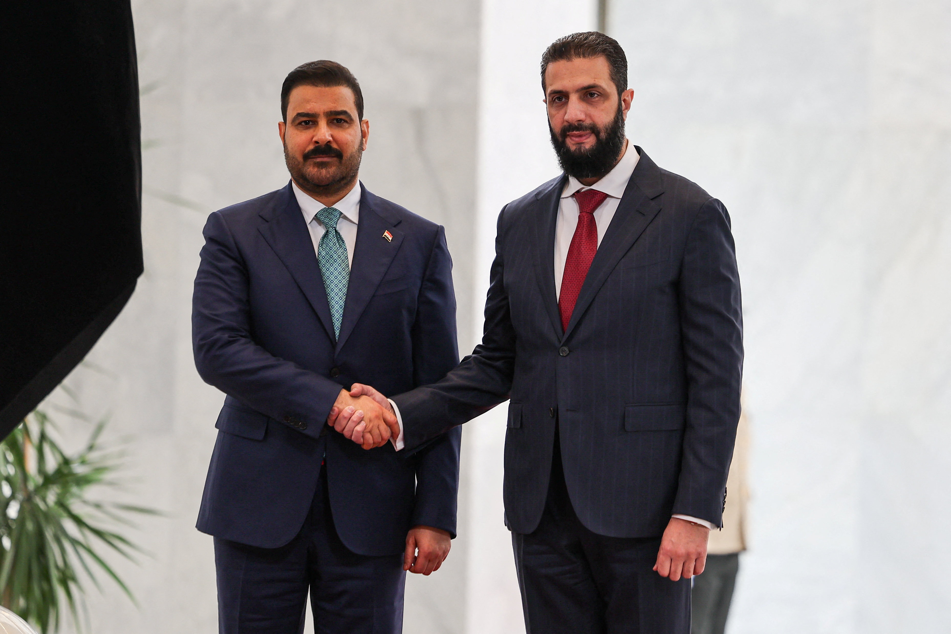 Syrian President Ahmed al-Sharaa and Iraqi Prime Minister Ali Faleh al-Zaidi shake hands as they meet at the People's Palace in Damascus, Syria, October 28, 2026. Reuters/Khalil Ashawi